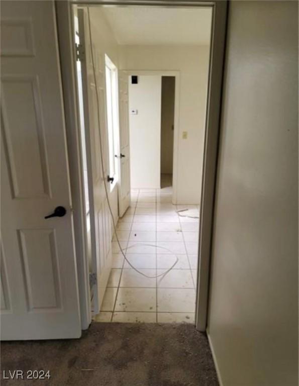 hall with light tile patterned flooring