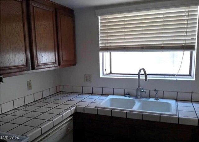 kitchen with sink, a wealth of natural light, and tile countertops