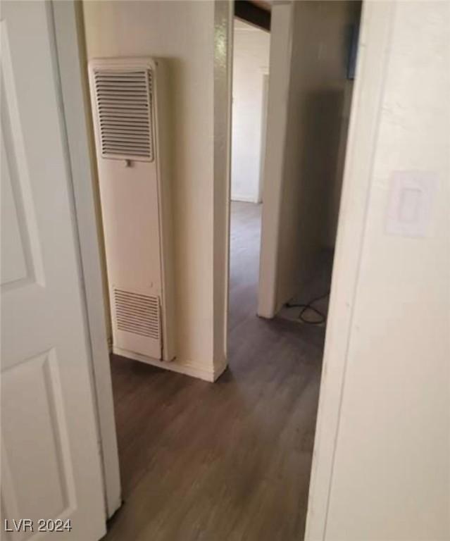 hallway with dark hardwood / wood-style floors