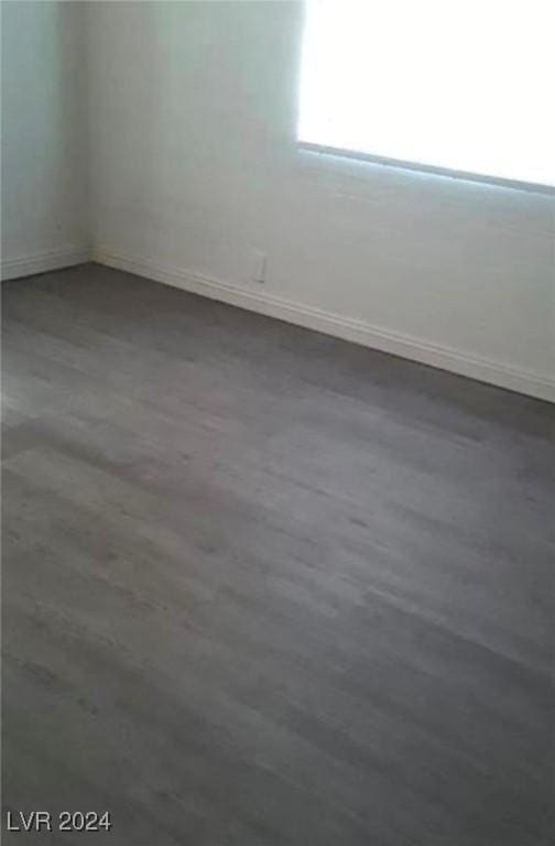 spare room with dark hardwood / wood-style floors