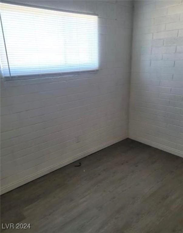 unfurnished room with wood-type flooring