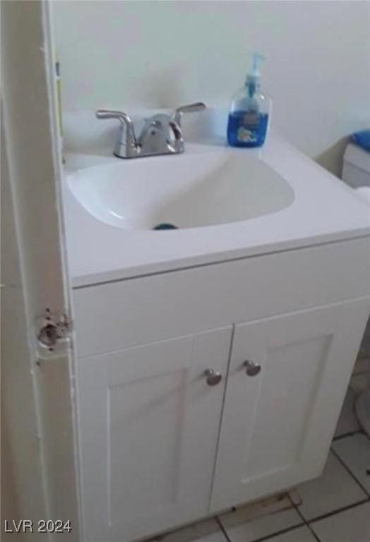 bathroom with vanity, tile patterned floors, and toilet