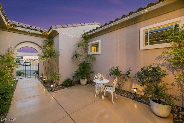 view of patio terrace at dusk