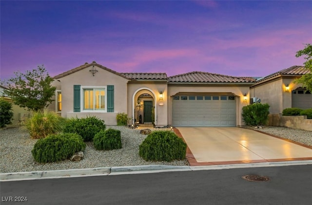 mediterranean / spanish-style home featuring a garage