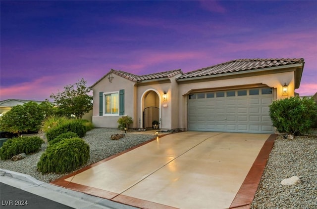 mediterranean / spanish-style home featuring a garage