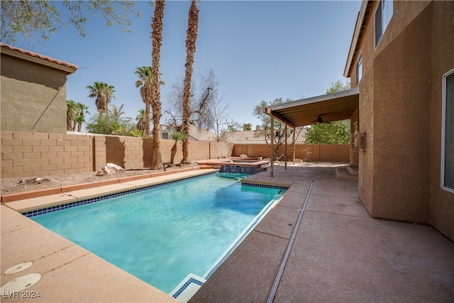 view of swimming pool with a patio and an in ground hot tub