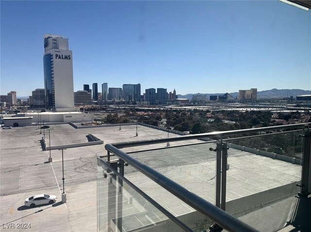 balcony featuring a mountain view and a city view