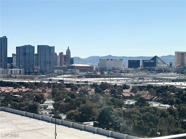 property's view of city with a mountain view