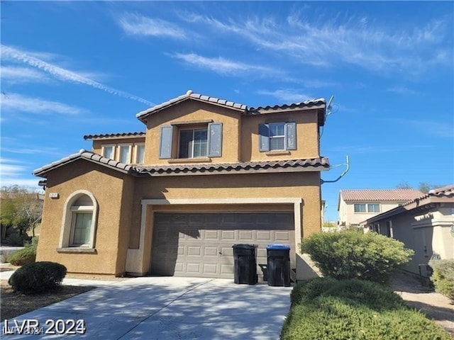 mediterranean / spanish-style house with a garage