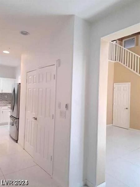 corridor featuring recessed lighting and light tile patterned floors