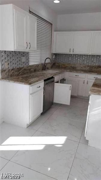 kitchen featuring a sink, marble finish floor, white cabinets, and dishwasher