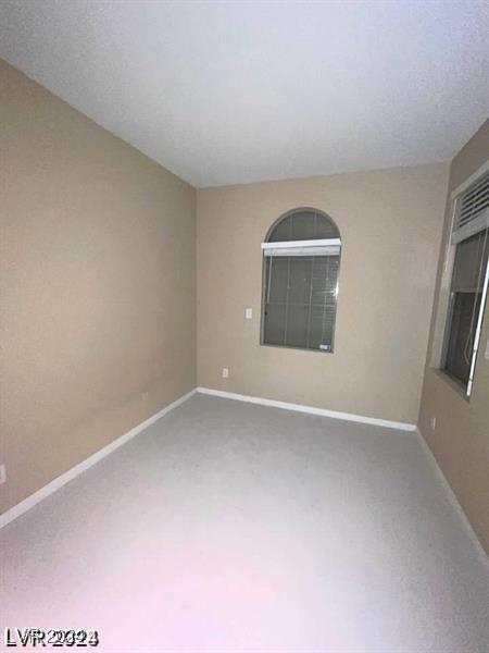 spare room with carpet floors and baseboards