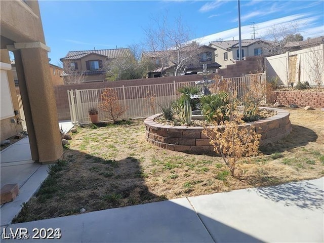 view of yard featuring a residential view and a fenced backyard