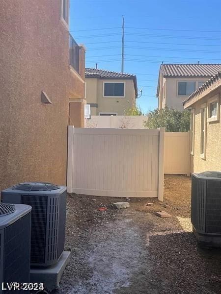 view of yard with fence and central air condition unit