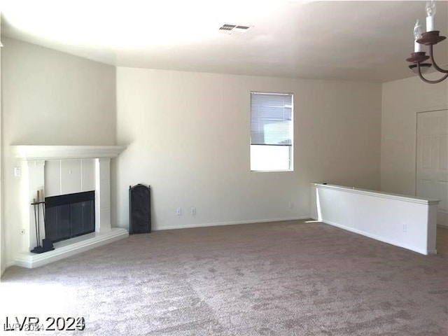 unfurnished living room featuring visible vents, a fireplace, and carpet floors