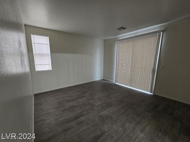 unfurnished room featuring visible vents and wood finished floors