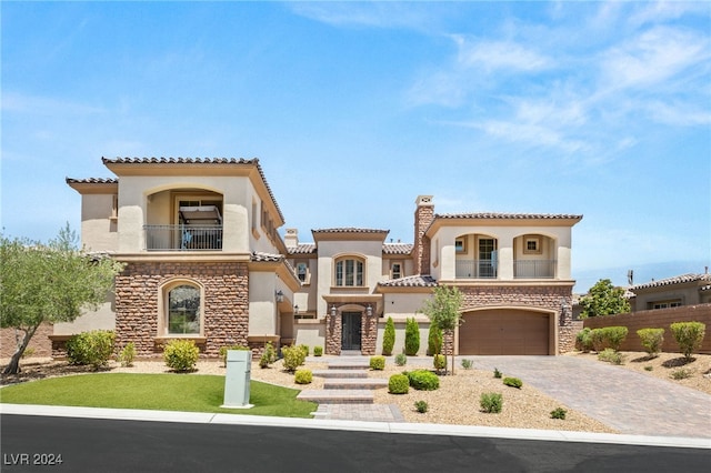 mediterranean / spanish-style home with a balcony and a garage