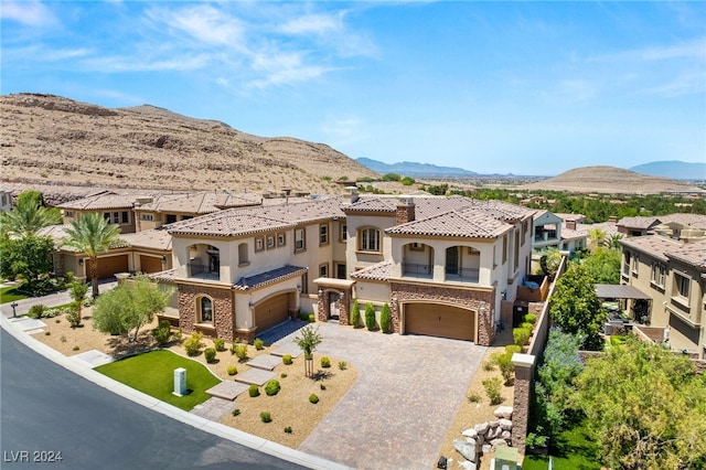 mediterranean / spanish-style house featuring a garage and a mountain view