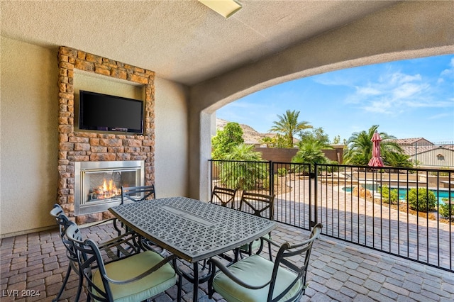 view of patio / terrace featuring an outdoor stone fireplace