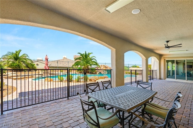 view of patio / terrace featuring a fenced in pool and ceiling fan