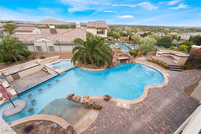 view of swimming pool featuring a patio and an in ground hot tub