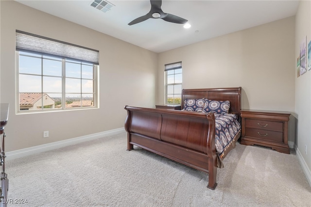 bedroom with ceiling fan and light colored carpet