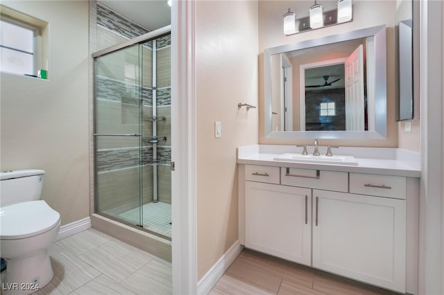 bathroom featuring vanity, toilet, and an enclosed shower