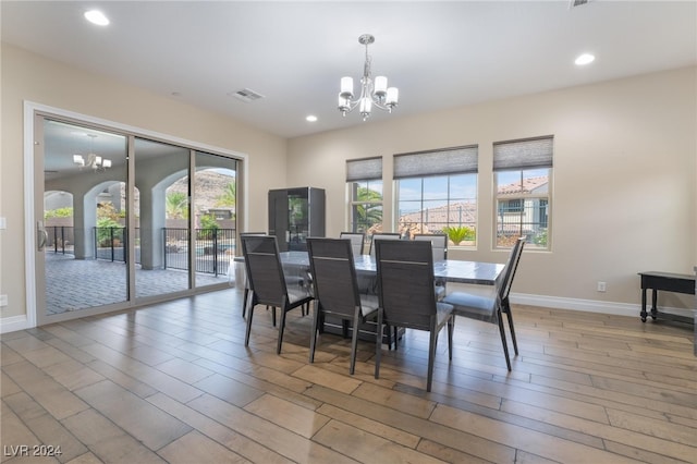 dining room with a chandelier, hardwood / wood-style flooring, and a healthy amount of sunlight