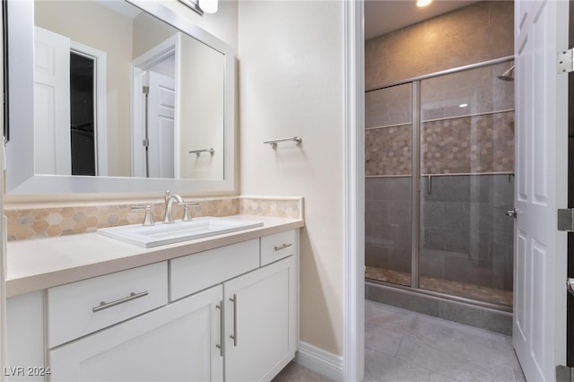 bathroom with vanity, tile patterned flooring, and a shower with door