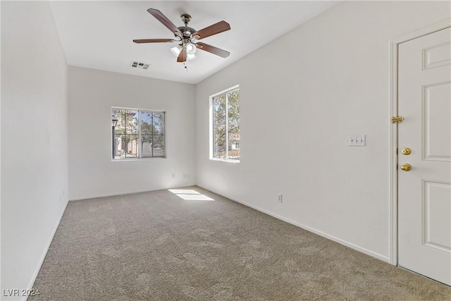 unfurnished room featuring carpet, visible vents, ceiling fan, and baseboards