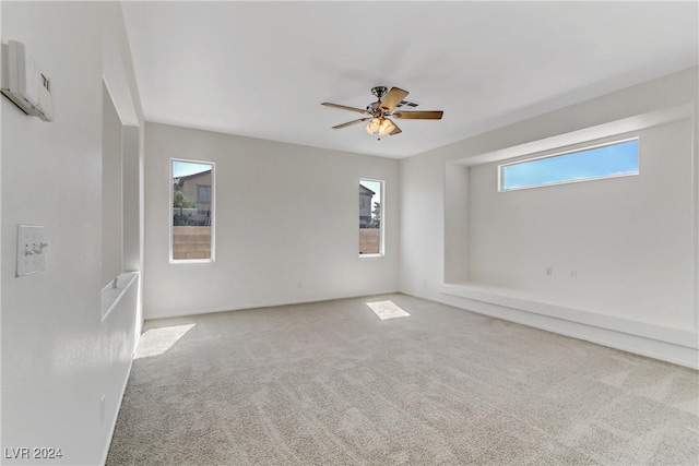 spare room with light carpet and ceiling fan