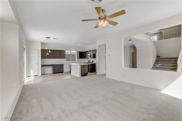 unfurnished living room with light carpet, visible vents, a ceiling fan, stairs, and baseboards