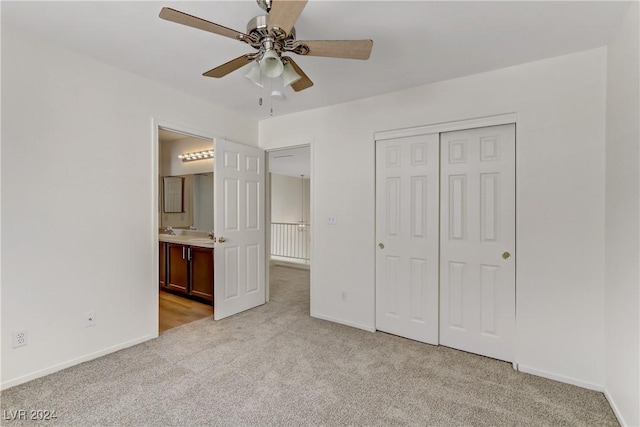 unfurnished bedroom featuring light carpet, a closet, and baseboards