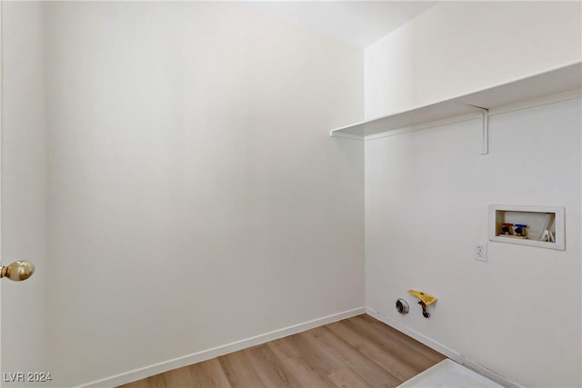 laundry area with light wood-type flooring, laundry area, baseboards, and washer hookup