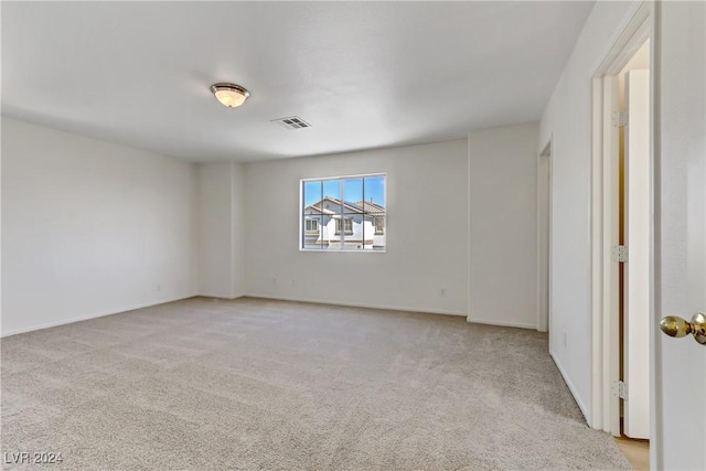 spare room with light carpet and visible vents