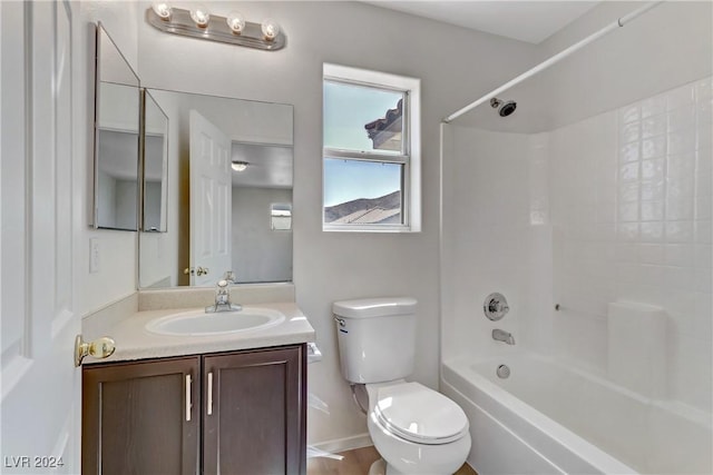 bathroom featuring baseboards, shower / bathing tub combination, vanity, and toilet