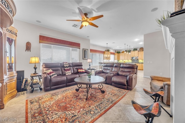 living room with light tile patterned floors, plenty of natural light, and ceiling fan