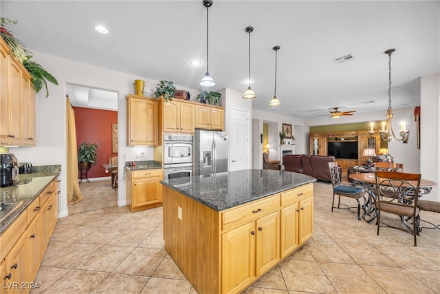 kitchen with dark stone countertops, stainless steel appliances, ceiling fan with notable chandelier, light tile patterned floors, and light brown cabinets