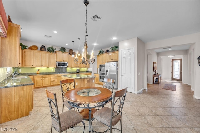 dining space with sink and light tile patterned floors