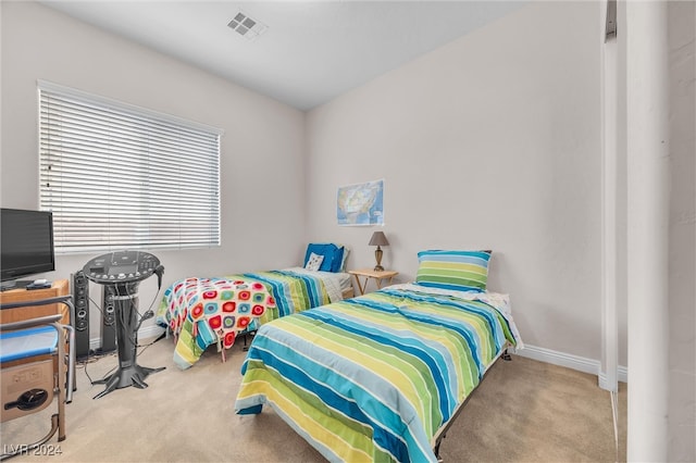 bedroom featuring light carpet