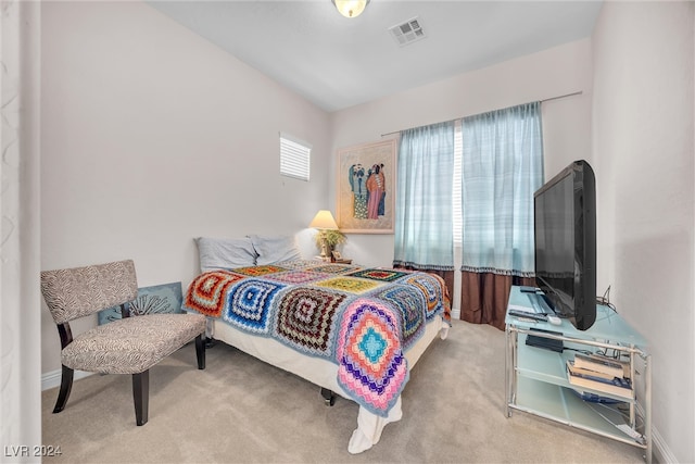 bedroom featuring light colored carpet