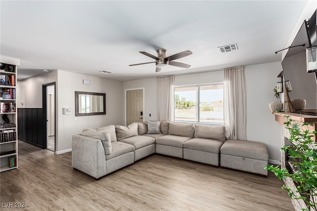 living room with hardwood / wood-style floors and ceiling fan