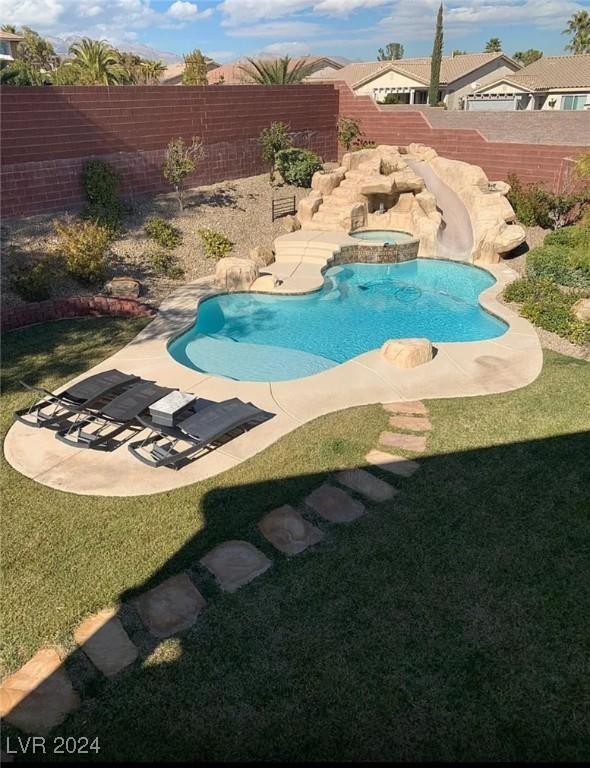 view of pool with a patio and a yard