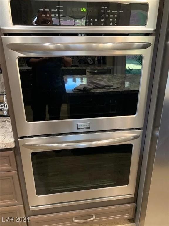 interior details featuring stainless steel double oven