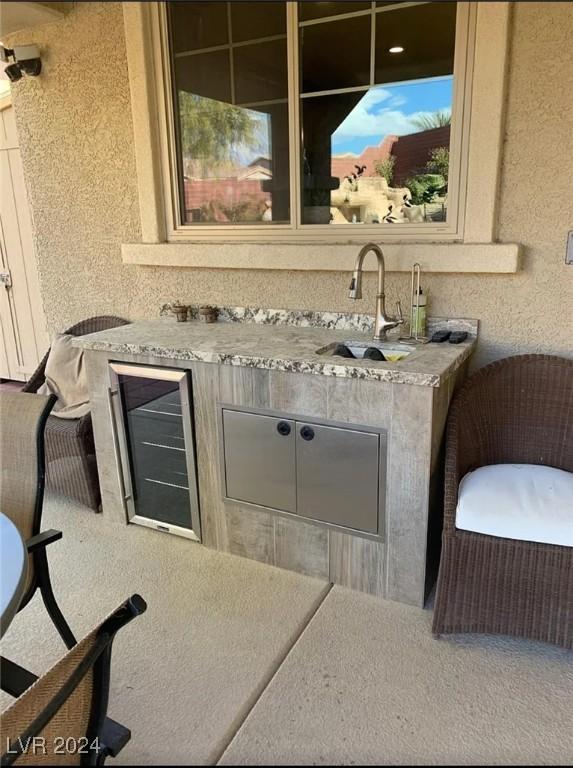 bar with wine cooler and sink