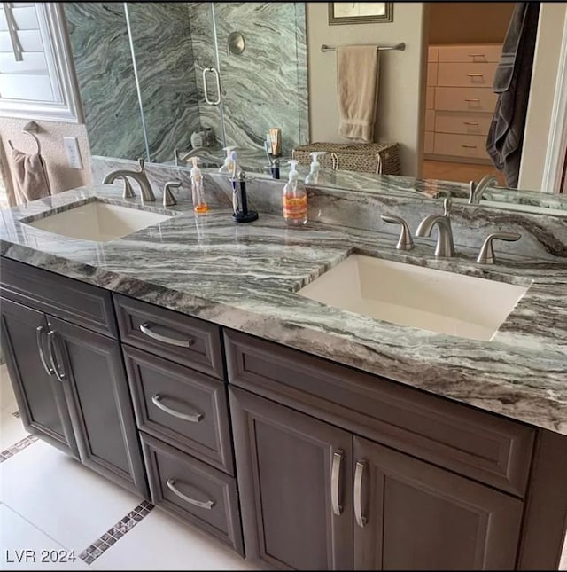 bathroom featuring vanity and a shower with shower door