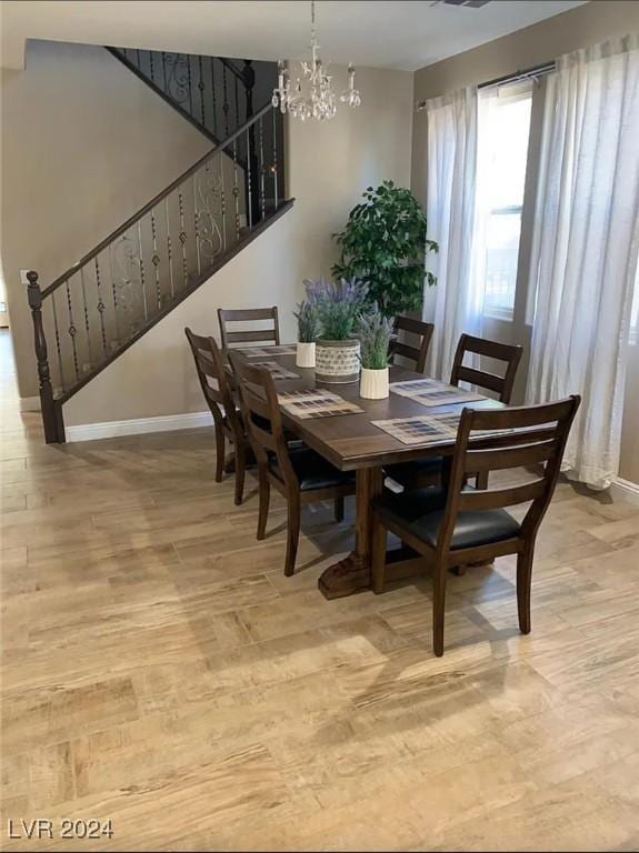 dining room featuring a chandelier and light hardwood / wood-style flooring