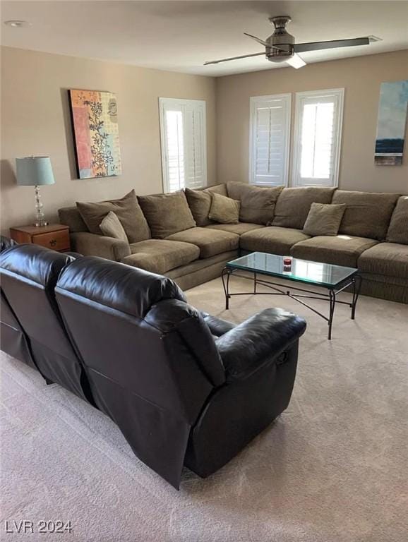 living room featuring light carpet and ceiling fan