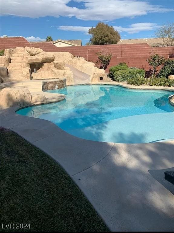 view of swimming pool featuring pool water feature