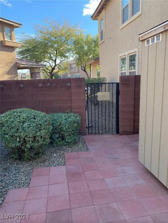 5301 Fairbranch Ln, Las Vegas, NV 89135 - view of gate featuring a patio area and fence